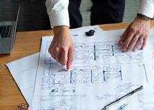 People looking at pool blueprints